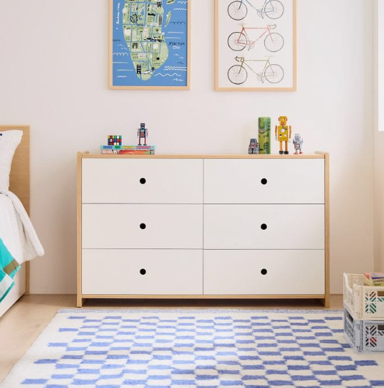 Small Bedroom Layout Ideas: How to Arrange Furniture in a Tiny Room Small bedroom layout idea featuring a modern wooden-framed white six-drawer dresser styled with toys, framed art prints, and a blue-and-white checkered rug.
