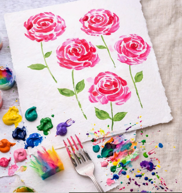Painted pink roses on textured paper, an easy DIY painting idea for crafts you can finish in one afternoon.