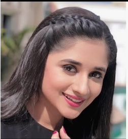 Low Maintenance Beauty Routine: A Simple 5-, 10-, and 15-Minute System A smiling woman with dark hair featuring a neat crown braid, styled as part of a low maintenance beauty routine.