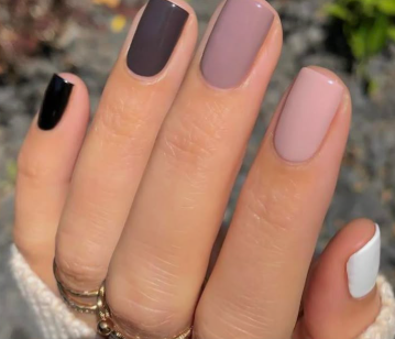 35 Short Nail Designs That Make Your Fingers Look Longer A close-up of short, square nails painted in a gradient of neutral and dark shades from white to black, styled as one of the short nail designs that make your fingers look longer.
