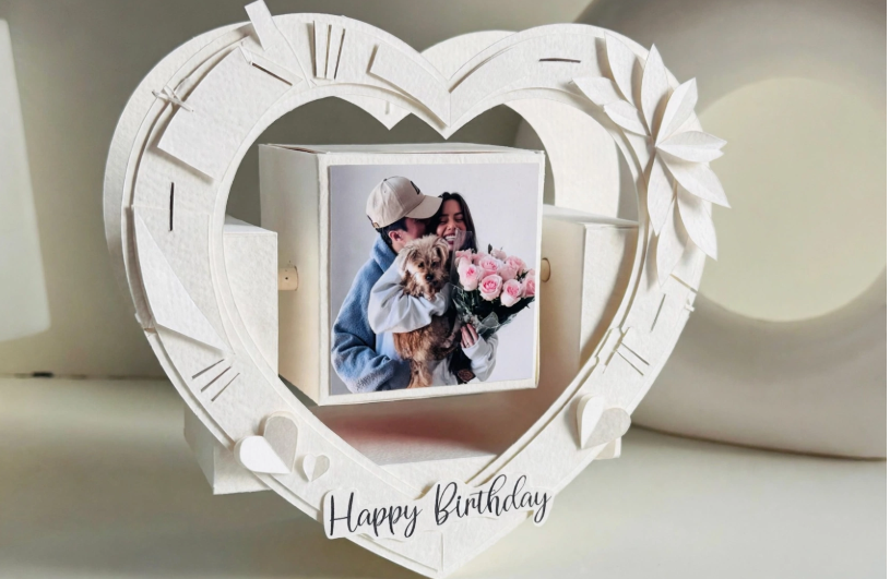 White 3D heart paper craft frame with rotating photo cube for handmade gift ideas on a budget.