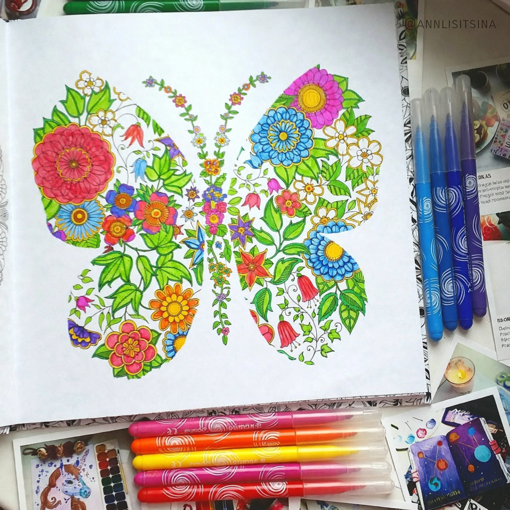 An intricate floral butterfly coloring page filled with bright markers on an art desk, presenting analog crafts to do instead of scrolling.   