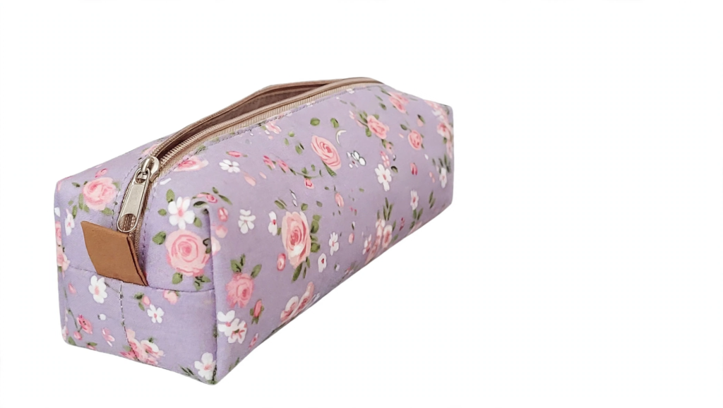 Handmade floral zippered pencil pouch in lavender fabric, featuring easy sewing craft ideas for teens[cite: 14].