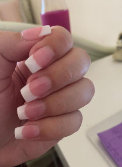 35 Short Nail Designs That Make Your Fingers Look Longer A close-up of short, square nails featuring classic white French tips on a natural pink base, serving as one of the short nail designs that make your fingers look longer.