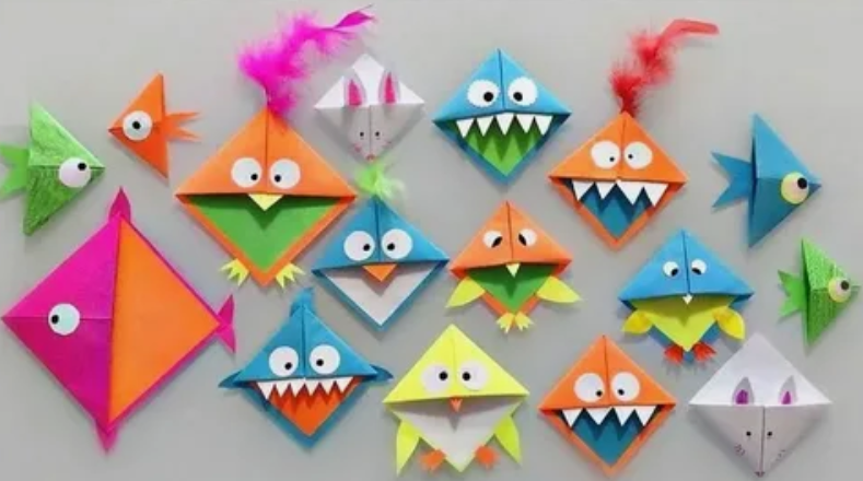 50+ Easy DIY Crafts to Sell and Make Extra Money Easy DIY crafts to sell: A collection of colorful origami paper crafts featuring cute monsters with jagged teeth, folded fish, and birds with googly eyes and feathered accents arranged against a neutral background.