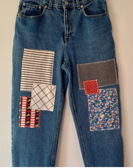 50+ Easy DIY Crafts to Sell and Make Extra Money Easy DIY crafts to sell: A pair of blue denim jeans customized with various colorful fabric patches sewn onto the legs, including stripes, checks, gingham, and floral prints.