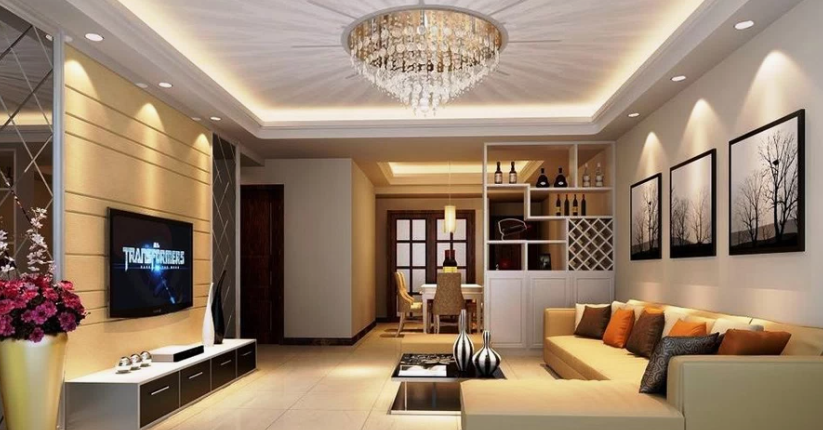 Small Living Room Decor Ideas on a Budget: 25 Stylish Ways to Make It Look Expensive Luxurious living room featuring small living room decor ideas on a budget with a beige sectional sofa, a wall-mounted TV over a media console, a modern chandelier with tray ceiling lighting, and framed wall art.