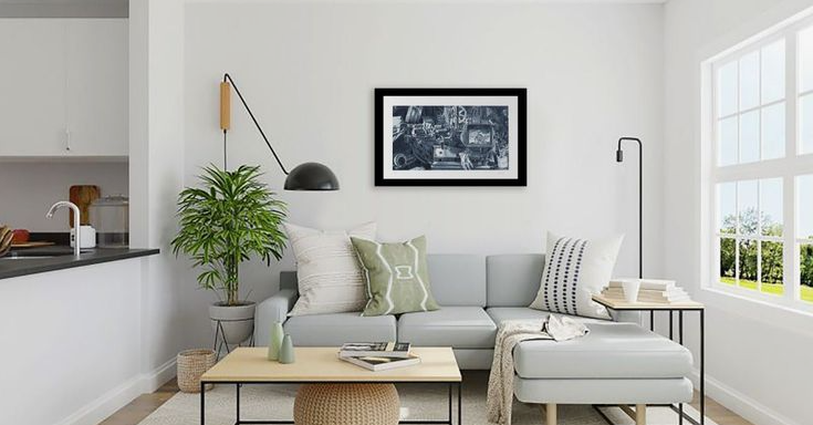 Small Living Room Decor Ideas on a Budget: 25 Stylish Ways to Make It Look Expensive Modern apartment living room featuring small living room decor ideas on a budget with a light gray sectional sofa, a wooden coffee table, a green potted plant, a black framed wall art piece, and a wall sconce.