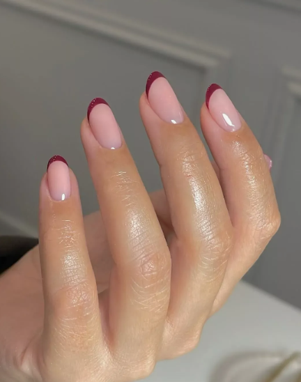 Short nail designs featuring elegant micro French tips in a rich burgundy shade on a natural glossy base.