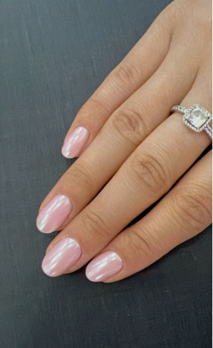 Short nail designs featuring a glossy, pearlescent pink chrome finish on neatly rounded short nails.