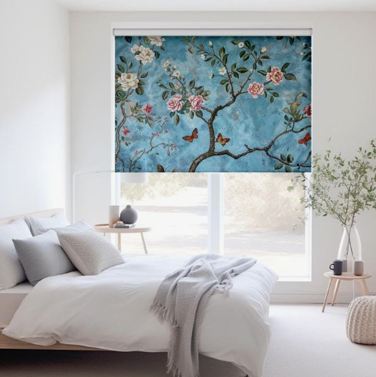 A bright bedroom featuring a vibrant blue floral roller blind with blossoming branches and butterflies, illustrating budget-friendly bedroom makeover ideas on a budget.