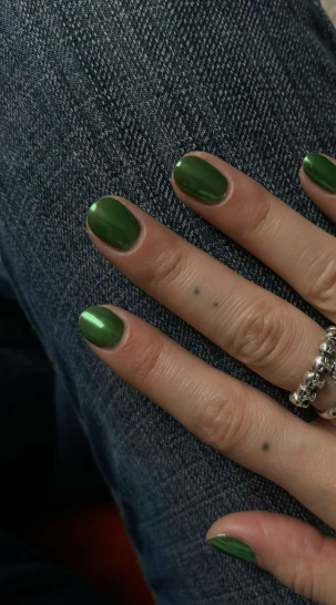 Short nail designs featuring glossy olive green polish on neat, rounded short nails.