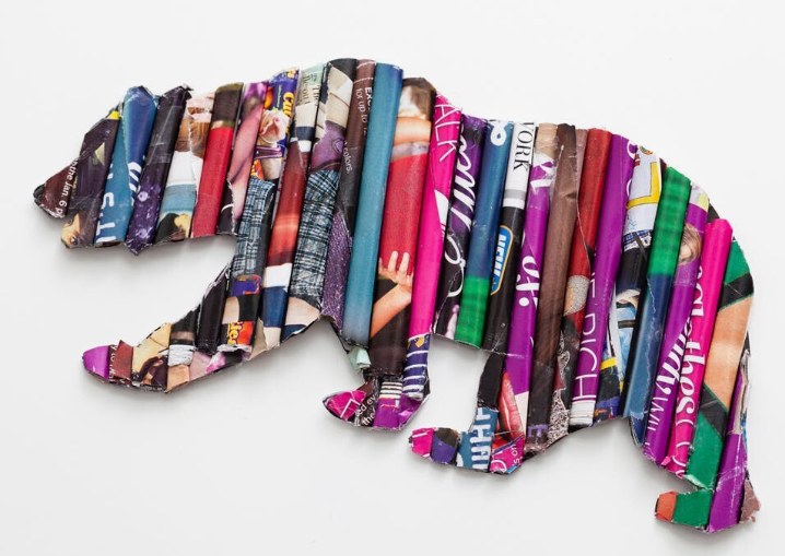A bear sculpture carefully crafted from rolled-up colorful magazine pages for DIY crafts using things you have at home.