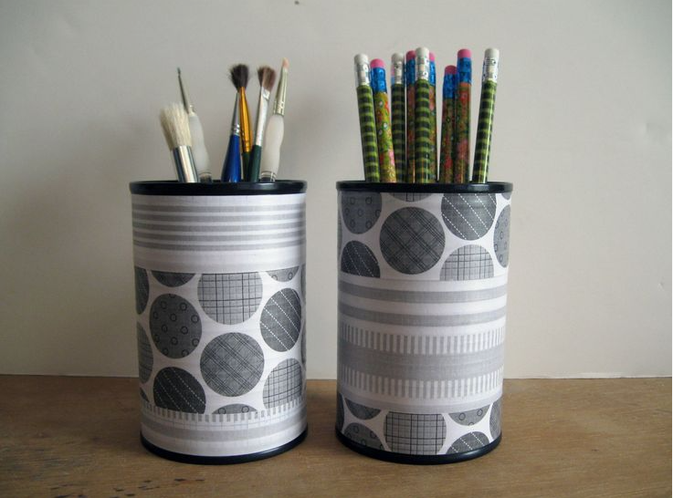 Two tin cans wrapped in gray and white patterned paper to create matching pencil holders for DIY crafts using things you have at home.