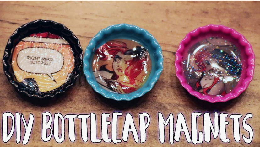 Three colorful painted bottle caps filled with resin and comic book artwork to create DIY crafts using things you have at home.