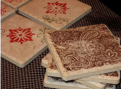 A stack of handmade stone coasters featuring stamped paisley and red floral patterns for DIY crafts using things you have at home.