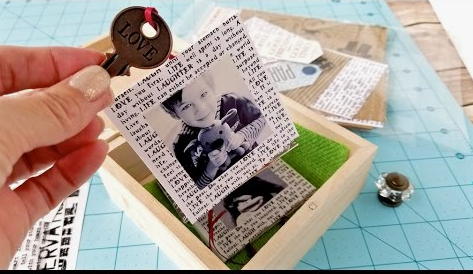 A handmade pull-out photo album hidden inside a small wooden box, featuring a "LOVE" key charm for DIY crafts using things you have at home.