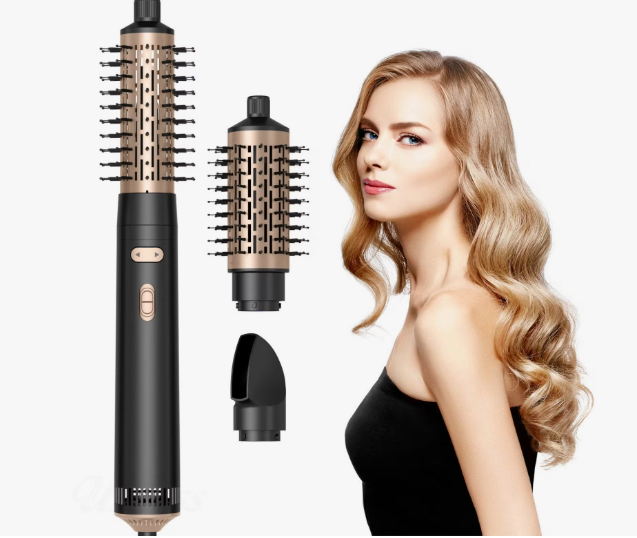 Woman with styled wavy hair posing next to interchangeable styling attachments and a hot air styling brush, showcasing beauty products worth buying.