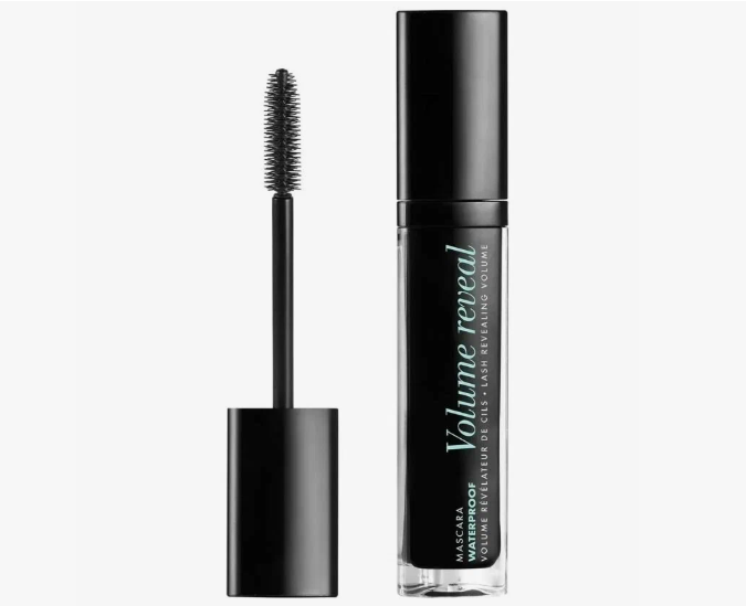 The Minimal Makeup Guide: How to Look Polished With Less Makeup A tube of Volume Reveal waterproof mascara standing upright alongside its black applicator brush against a plain white background.