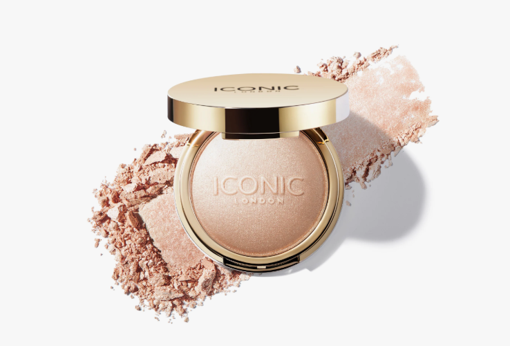 The Minimal Makeup Guide: How to Look Polished With Less Makeup An open gold compact of Iconic London highlighter powder resting on a matching powder swatch against a clean white background.
