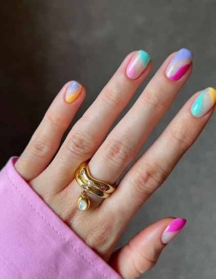 Short, neutral, colorful curved wave nail art on short rounded nails highlighting low-maintenance nail designs.