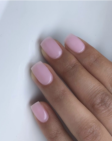Short square milky pink nails showcasing low-maintenance nail designs.