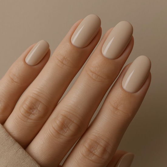 Glossy opaque beige oval nails showcasing low-maintenance nail designs.