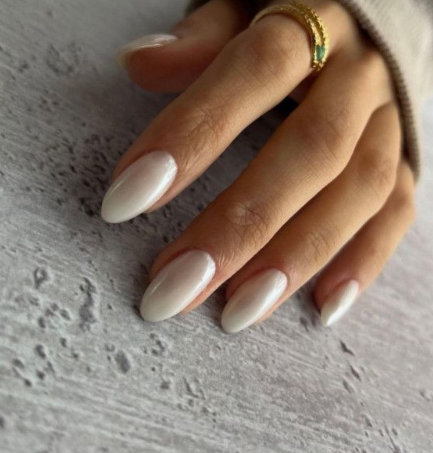 Glossy pearlescent white almond nails showcasing low-maintenance nail designs.