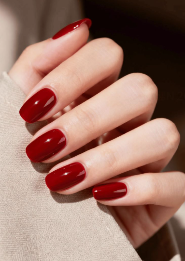 Glossy classic red short nails showcasing low-maintenance nail designs.