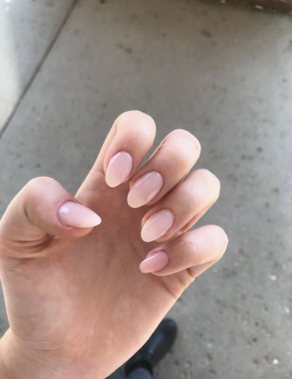 Glossy sheer nude almond nails showcasing low-maintenance nail designs.
