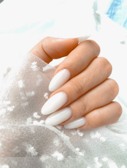 Glossy milky white almond nails showcasing low-maintenance nail designs.