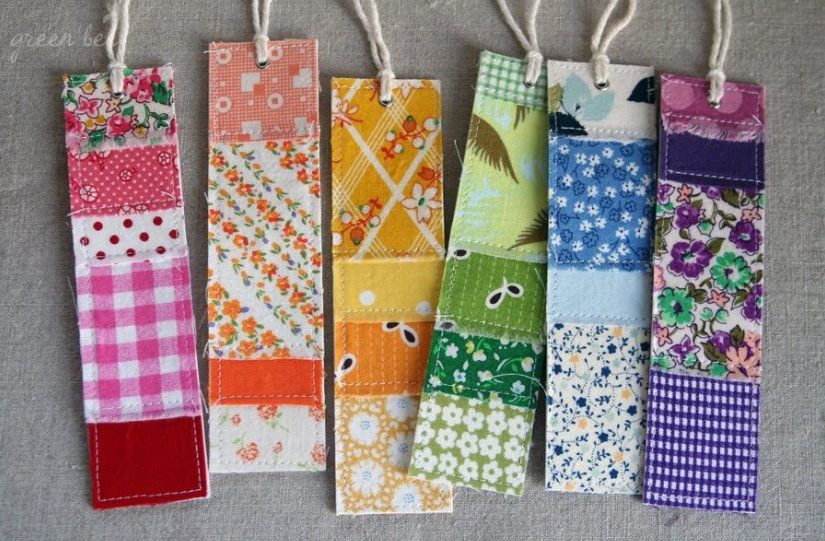 A set of colorful fabric bookmarks featuring patchwork patterns, stitched sections, and top-loop strings.