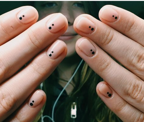 Short, neatly manicured nails featuring a minimalist design with two small black dots near the base of each nail, perfect for easy nail designs for short nails.