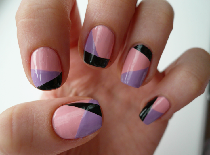 Short, well-kept nails featuring a geometric color-blocked design in soft pink, lavender, and black swoops, serving as a creative example of easy nail designs for short nails.