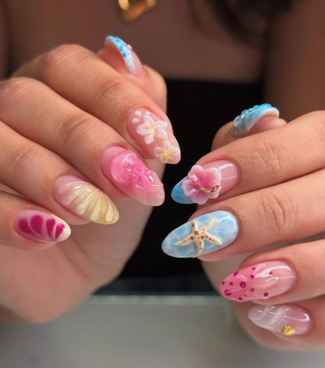 15 Stunning 3D Nail Designs to Try This Season Vibrant 3D nail designs showcasing a mix of summer beach themes, sculpted tropical flowers, and seashell accents on an almond-shaped manicure.