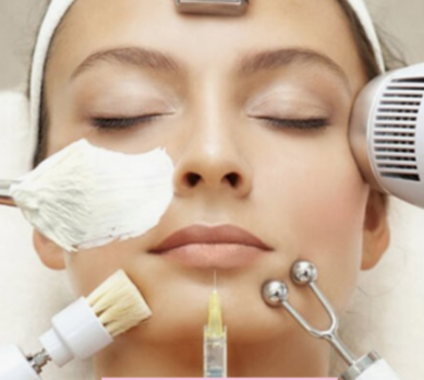 A close-up view of a woman receiving a multi-step spa facial treatment surrounded by various beauty devices and tools, highlighting the complex contrast to a simple skincare routine for beginners.