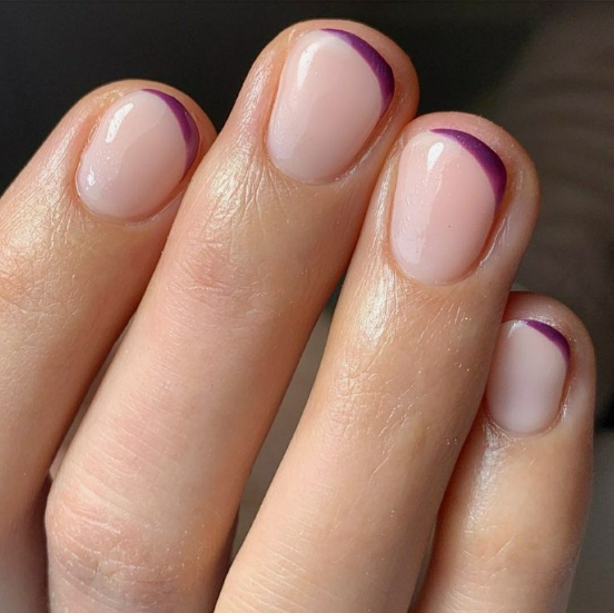 Short, rounded nails with a glossy nude base and slim, elegant dark purple tips, offering a chic option for nail designs for short nail beds.