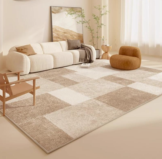 A cozy, neutral-toned living room featuring a large geometric checkered area rug in beige and brown tones, a white sectional sofa, and various wooden seating accents, beautifully illustrating how to decorate when everything doesn't match.