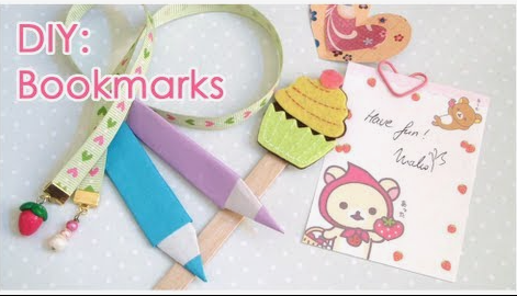 A variety of handmade bookmarks including ribbon bookmarks with charms, folded paper pencil bookmarks, and a felt cupcake bookmark, demonstrating cheap DIY crafts on a budget.