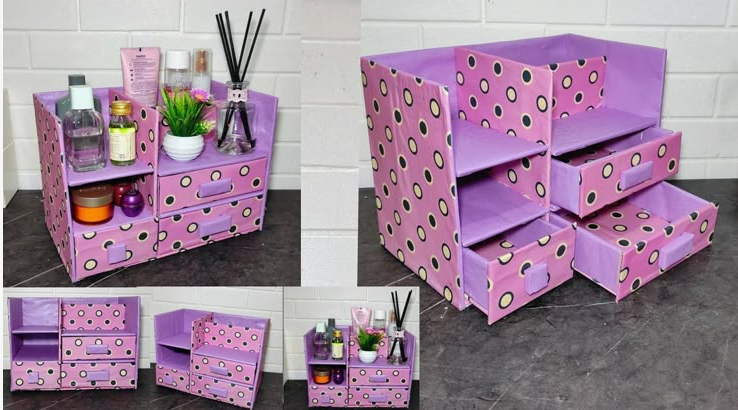 A multi-compartment desk organizer crafted from cardboard and covered in purple and pink polka-dot paper, featuring open shelves and miniature drawers, showcasing cheap DIY crafts on a budget.