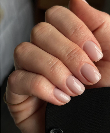 Clean, short nude-pink glossy office-friendly nail designs featuring a minimalist, professional manicure.