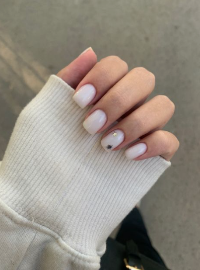 Short milky white square nails with a subtle star and rhinestone accent, perfect for clean office-friendly nail designs.