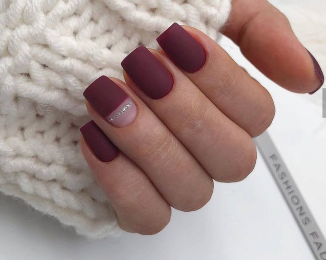 Short square matte burgundy nails featuring a negative space accent nail with a delicate silver glitter line, adding a chic touch to office-friendly nail designs.