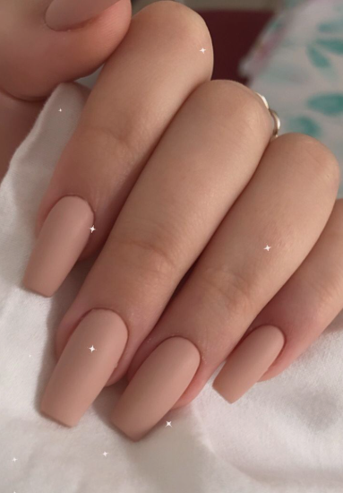 Long coffin-shaped matte nude nails with a smooth finish, creating a sleek and sophisticated look for office-friendly nail designs.