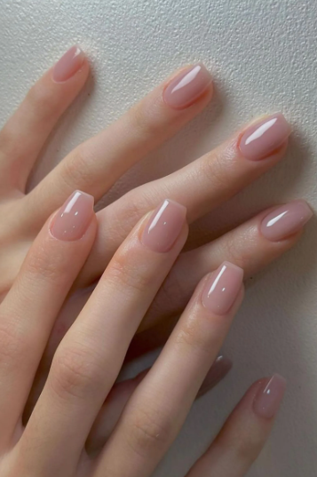Short square-oval neutral pink glossy jelly nails with a clean and polished finish, offering a versatile choice for office-friendly nail designs.