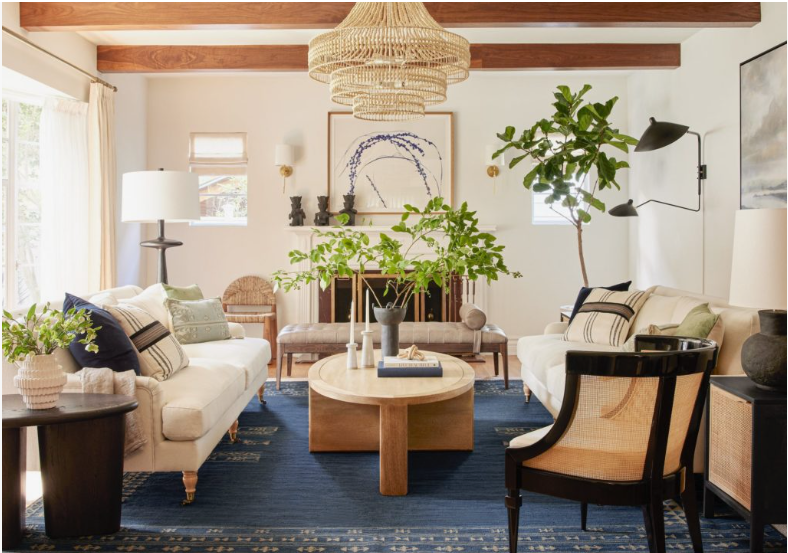 How to Make a Boring Room Look Better: 15 Simple Fixes Bright living room styled with a bold blue rug, neutral sofas, and natural wood accents, showcasing key principles for how to make a boring room look better.