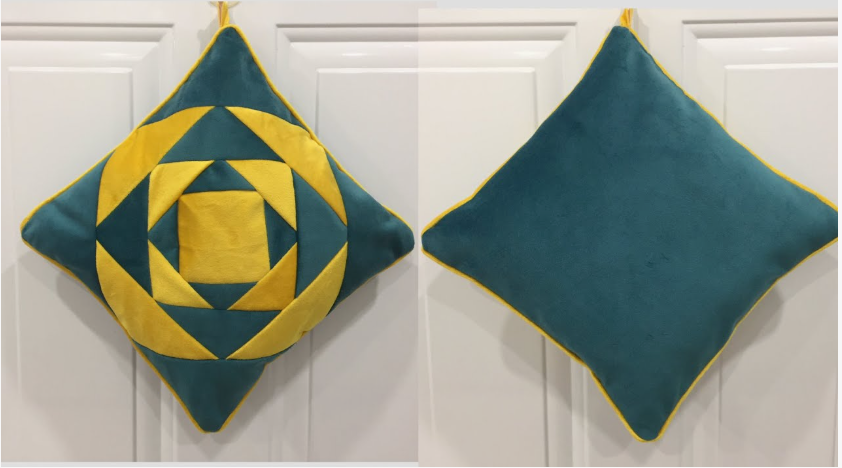 20 No-Sew DIY Crafts for Adults Side-by-side view of a handmade decorative pillow featuring a geometric teal and yellow quilted pattern on one side and solid teal fabric on the reverse, highlighting inspiring no-sew DIY crafts for adults.