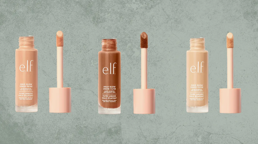 Three shades of e.l.f. Halo Glow Liquid Filter bottles with their doe-foot applicators displayed against a textured green background, showcasing best drugstore beauty products under $20.