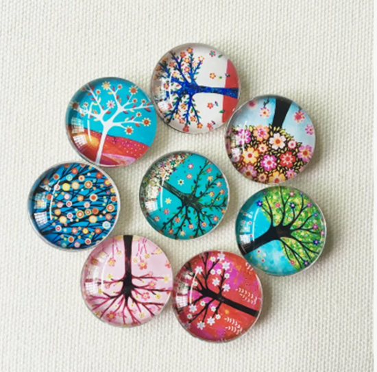 A collection of eight colorful glass cabochon magnets featuring vibrant tree illustrations, presented as a DIY craft project under the keyphrase one hour crafts.