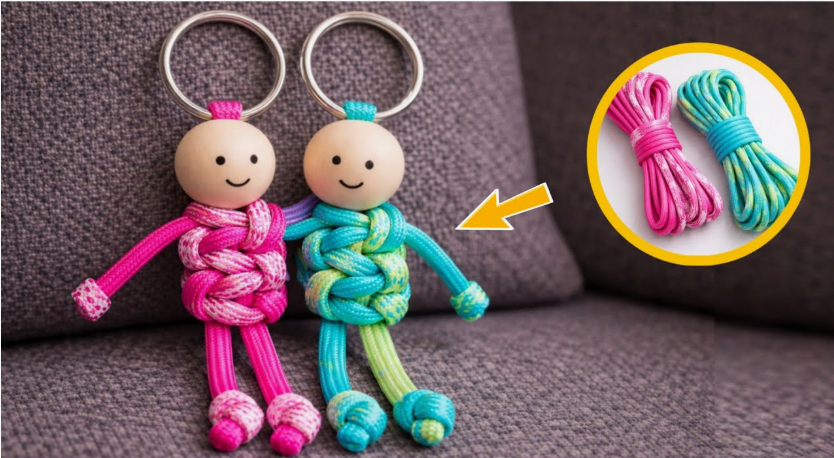 A pair of cute, handmade buddy keychains crafted from paracord cords and wooden bead heads with smiling faces, presented as a DIY craft project under the keyphrase one hour crafts.